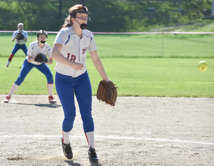 Oak Hill pitcher Sadie Waterman delivers a pitch while second baseman Emily Ahlberg and right fielder Rylea Swan get into a defensive positions during a Mountain Valley Conference game against Monmouth on Friday.