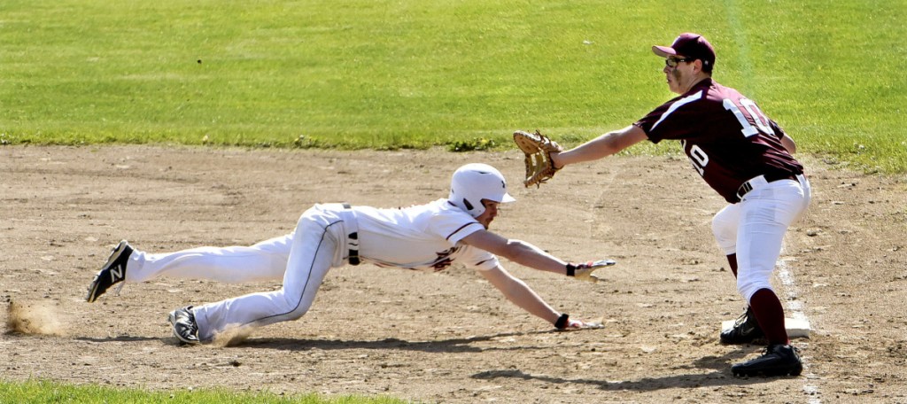 Nokomis' Josh Emery fields throw as a Skowhegan runner makes it back to first base Monday in Skowhegan.