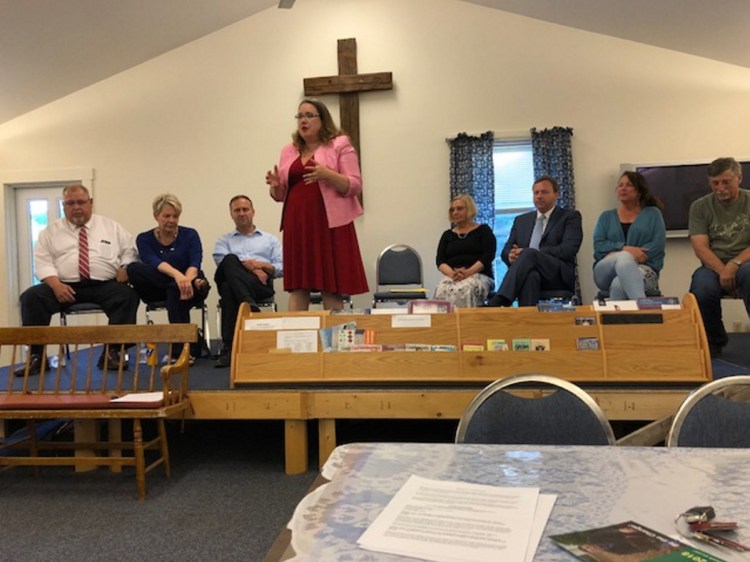 Gubernatorial candidate Diane Russell speaks to about 50 people who turned out Wednesday night for a candidates forum at South China Community Church. Seated behind her are, from left, gubernatorial candidates Mark Dion, Elizabeth Sweet, and Adam Cote; China resident Dawn Castner, who is running for state House District 79; gubernatorial candidate Mark Eves; and Kellie Julia and John Glowa, who are running for Senate District 15.