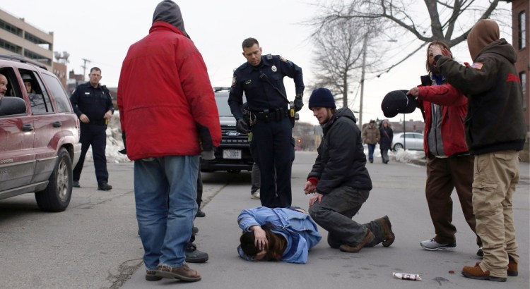 Police respond to a woman whose head was injured after she was pushed to the ground on Oxford Street in March. Portland's police chief says Bayside has been the department's busiest patrol area throughout his 21-year career.