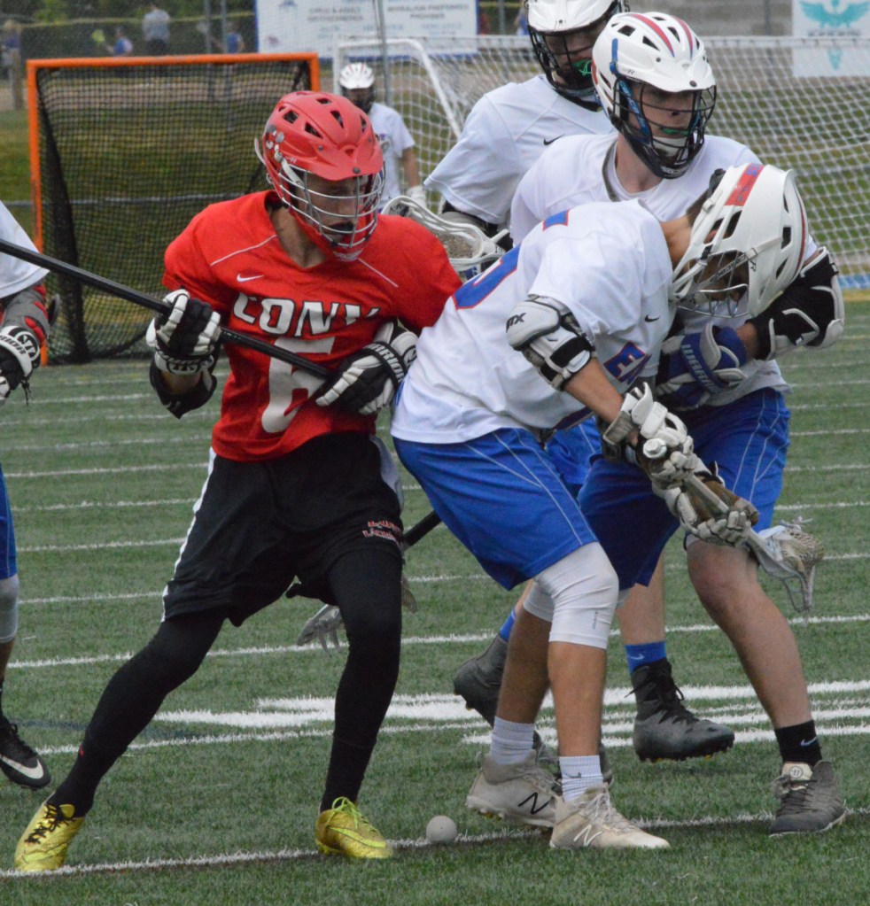 Sun Journal photo by Eric Maxim 
 Cony's Bradley Houston (6) battles with Mt. Ararat's Connor Brown (15) and Matt Lawrence (9) during a Class B prelim game Wednesday in Topsham.