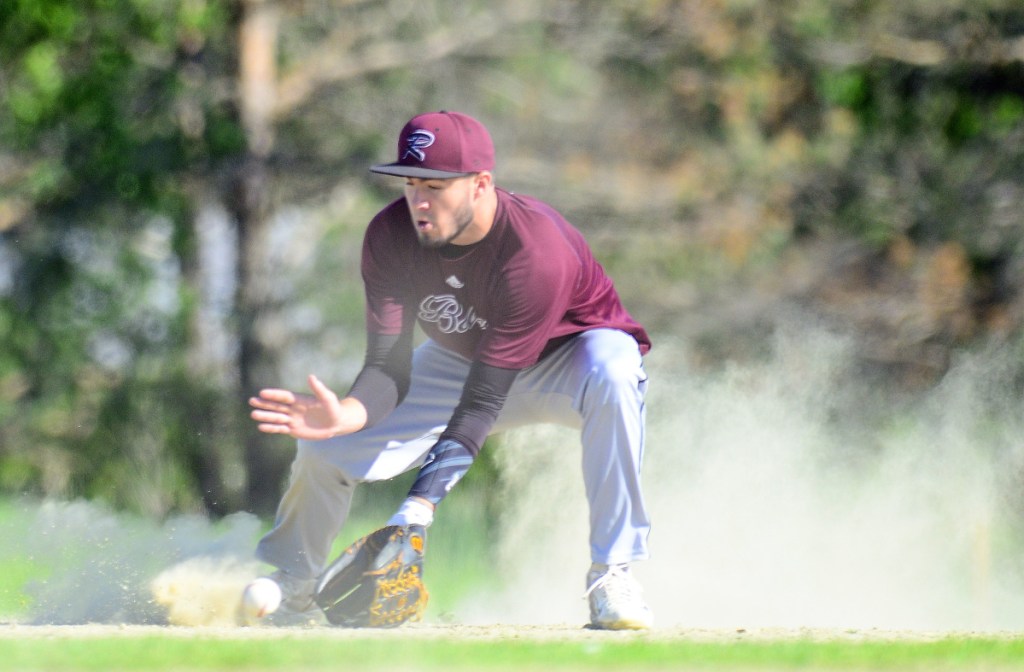 Staff photo by Joe Phelan
Richmond shortstop Matt Rines fields a grounder in the dust during a Class D South semifinal game Friday at Richmond High School.