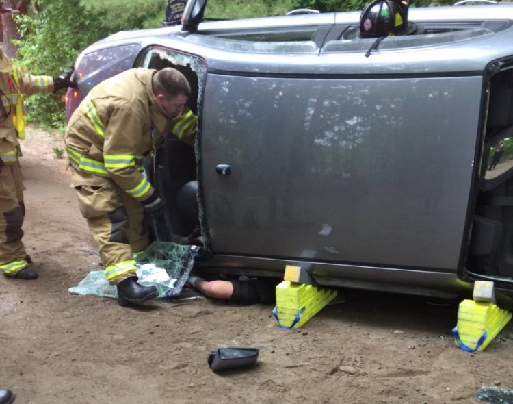 Windham Fire/Rescue attempt to remove a man involved in rollover. 