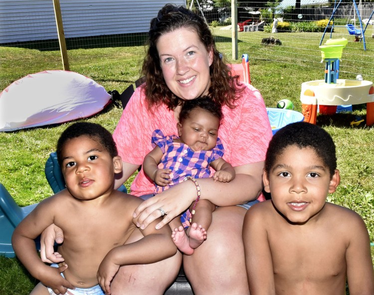 Mindy Saint Martin sits with her children Marcus, left, 2-month-old Mya and Donovan at their home in Waterville on Monday. Her husband, Lexius, has been deported to Haiti. His case is scheduled to be heard by a pardon board in Augusta July 19. The three-member panel will recommend to the governor whether Lexius Saint Martin should be pardoned for his crime, which the family hopes will lead to his return to Waterville.