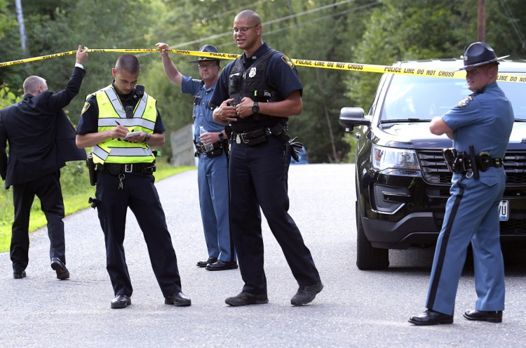 Maine State Police and Gardiner police gather Thursday evening at an incident involving two deaths on Timberwood Drive in Gardiner.