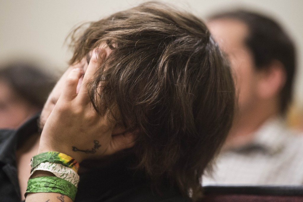 Noah Goodridge holds his head in his hands Wednesday in Skowhegan District Court as he waits to enter a not guilty plea to an assault charge in connection with a June 12 incident involving a Skowhegan police officer. Goodridge says he had a seizure and the police officer, who arrested him, misunderstood what was happening.