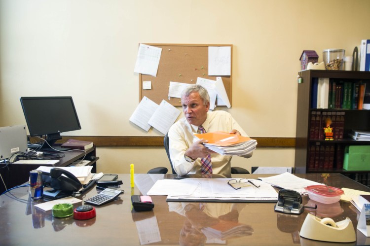 Superior Court Justice Robert Mullen talks on Friday about the problem of getting people to show up for jury duty from his chambers at the Somerset Superior Court in Skowhegan. Mullen is holding a thick file of paperwork about juror candidates who were dismissed as ineligible to serve in an upcoming trial.