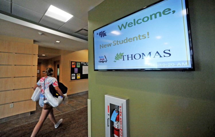 A new Thomas College student moves her belongings into her dormitory room in 2017 at Hinman Hall in Waterville.