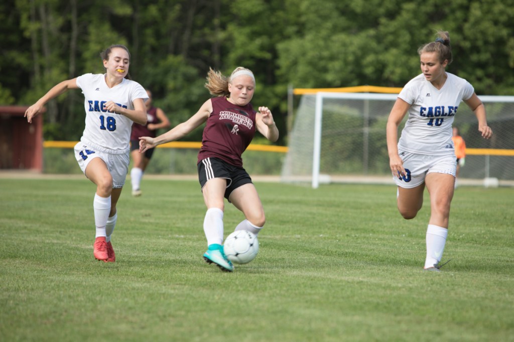 Eyes on the ball: Erskine's Jordan Linscott (18) and Alyssa Savage (10) converge on Monmouth's Alicen Burnham during an exhibition game last month in  Monmouth.