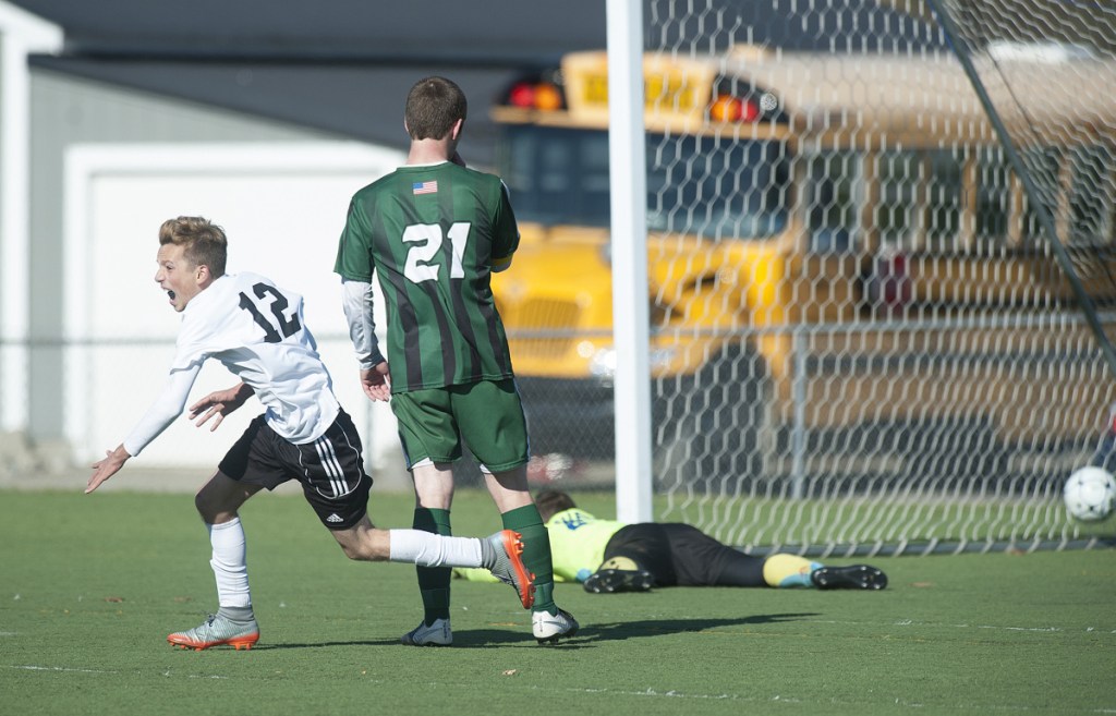 Photo by Kevin Bennett 
 Late strike: Wyatt Lambert runs to celebrate with his Maranacook boys soccer teammates after Silas Mohlar scored with 20 seconds left in regulation to give the Black Bears a 1-0 victory over Fort Kent in the Class C state title game last season at Hampden Academy.