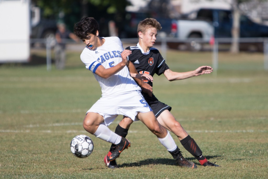 Erskine senior Sage Hapgood-Belanger takes control of the ball as Gardiner sophomore Tucker Boudreau defends during a Kennebec Valley Athletic Conference Class B game Friday in Gardiner.