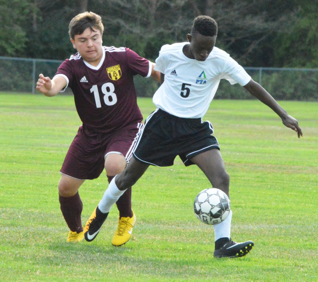 Richmond's Derek Barrett (18) battles with Pine Tree Academy's Nshimiye Gasuminari (5) during Thursday's Class D South soccer game in Richmond.