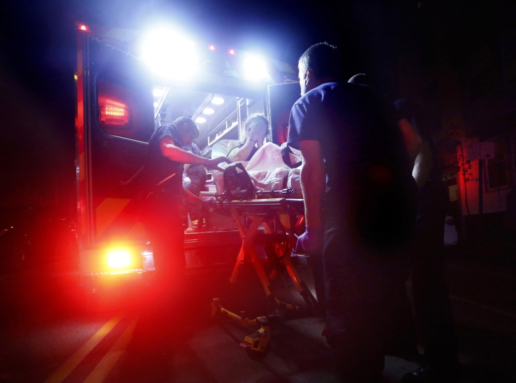 Portland paramedics respond last August to a call of a heroin overdose on Congress Street near the intersection of India Street. 