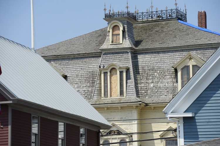 Robert Indiana's home on Vinalhaven, the former Odd Fellows Hall named Star of Hope, is shown with some of the windows boarded up last May.