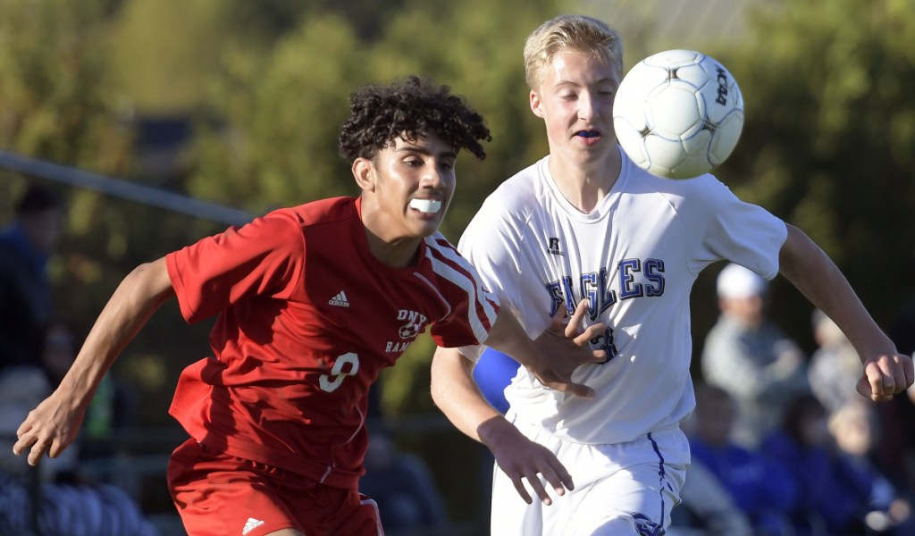 Cony's Ali Albraihi tries to get separation from Erskine's Aidan Larrabee during a Kennebec Valley Athletic Conference game against Cony  on Wednesday in Augusta.