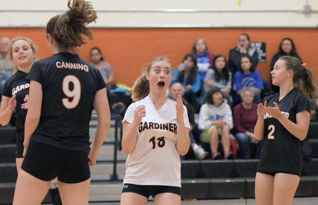 Gardiner's Elly Basinger, center, reacts to a point during a volleyball match Thursday in Gardiner.