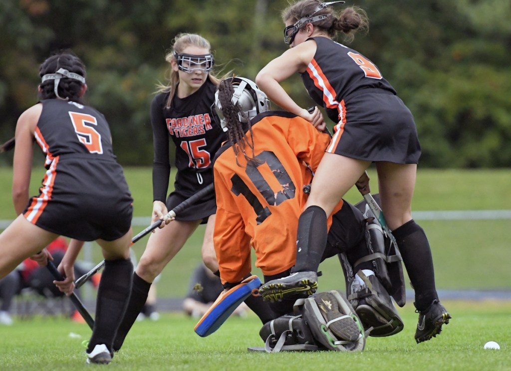 Staff photo by Andy Molloy 
 Winslow goalie Justice Picard (10) is surrounded by Gardiner players Sarah Faust, left, Maggie Bell and Maddie Farnham during a recent game in Gardiner.