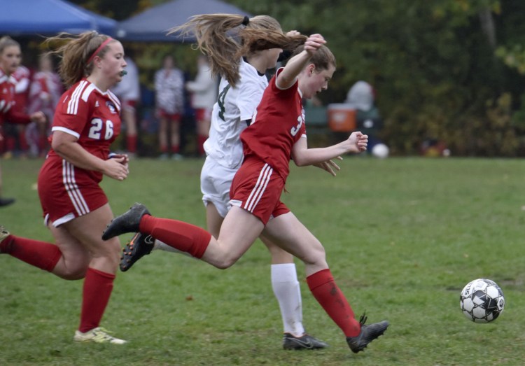 Messalonskee's Grace Bourgoin (26) and Ella Moore run with Oxford Hill's Ella Kellogg after the ball during a game on Monday in Oakland.