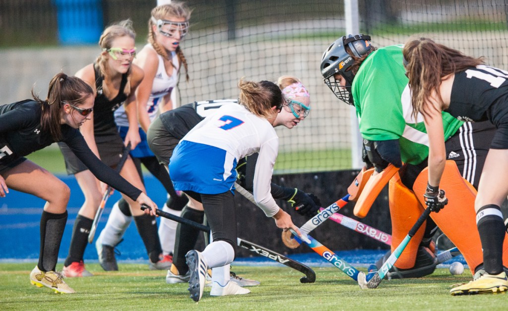 Sun Journal photo by Russ Dillingham 
 Oak Hill's Kaylei Robichaud, center, looks to get a rebound off St. Dominic goalie Simone Long on Wednesday in Lewiston.