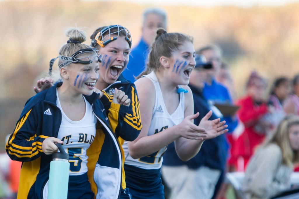 Photo by Jennifer Bechard 
 Mt. Blue's Farrah Ballou, left, Whitney Fraser, center, and Kelsey Dorman cheer as the Cougars defeated Cony in a Class A North semifinal game Saturday afternoon in Farmington.