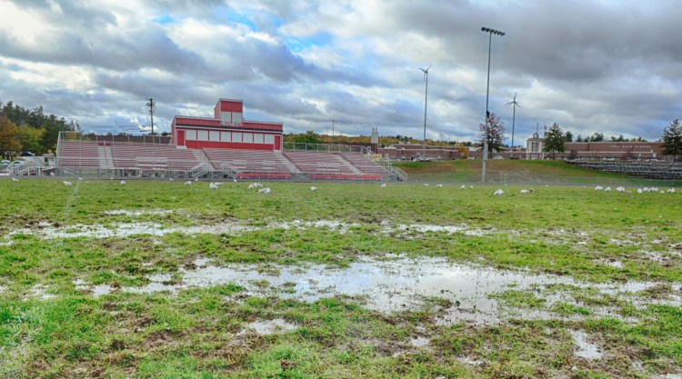 Water puddles dot the muddy surface of Alumni Field at Cony High School. The school announced Wednesday that it will play its Pine Tree Conference Class B semifinal game Nov. 2 at Lewiston High School because Alumni Field isn't suitable to host a game.