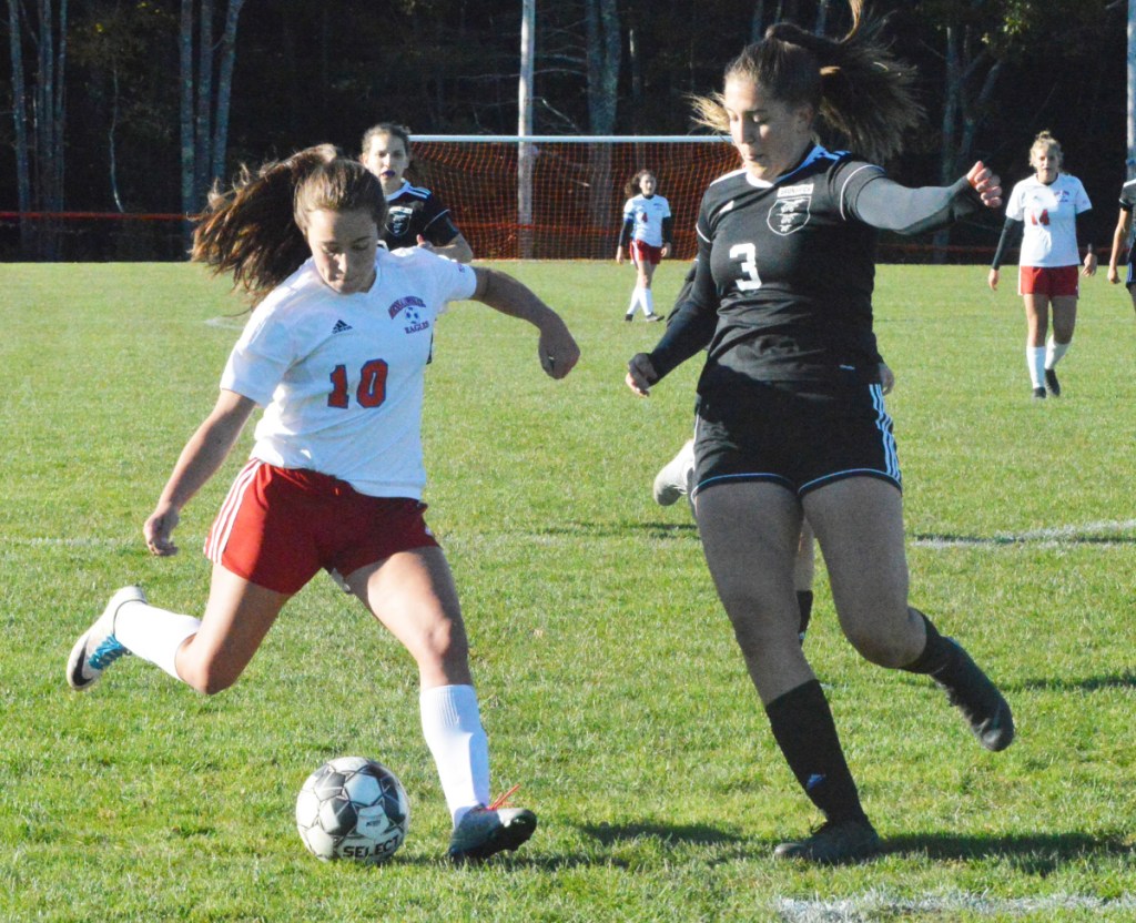 Messalonskee's Caitlin Parks (10) is about to send a shot on goal with pressure coming from Brunswick's Alexis Guptil (3) in Friday's Class A North semifinal game in Brunswick.