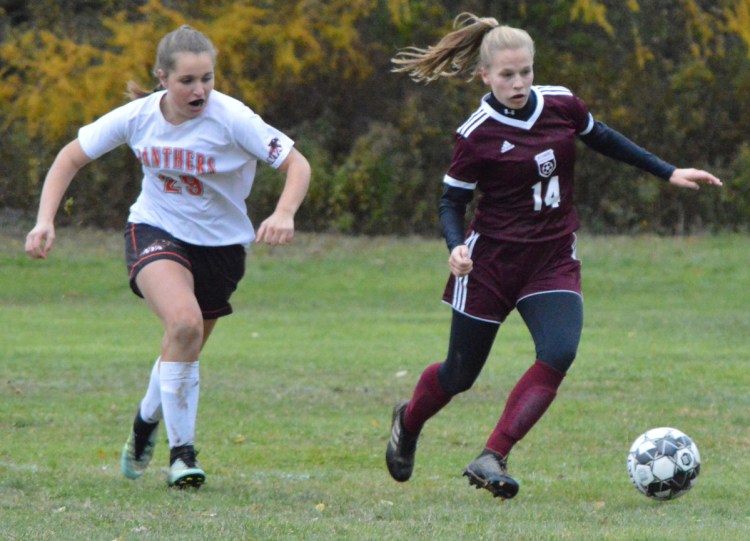 Richmond's Caitlin Kendrick (14) dribbles up the the field as NYA's Madison Argitis pursues during the Class D South regional final Wednesday in Richmond.