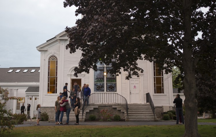 Attendees say goodbye after attending a prayer vigil for Kristin Westra at the Congregational Church in Cumberland on Saturday.