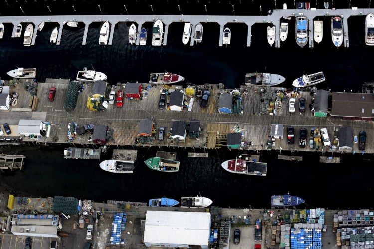 Fishing boats are docked along the waterfront in 2013. Fishermen and other marine businesses began agitating last year as they began to feel hemmed in by new hotels, office and shopping developments on Commercial Street.