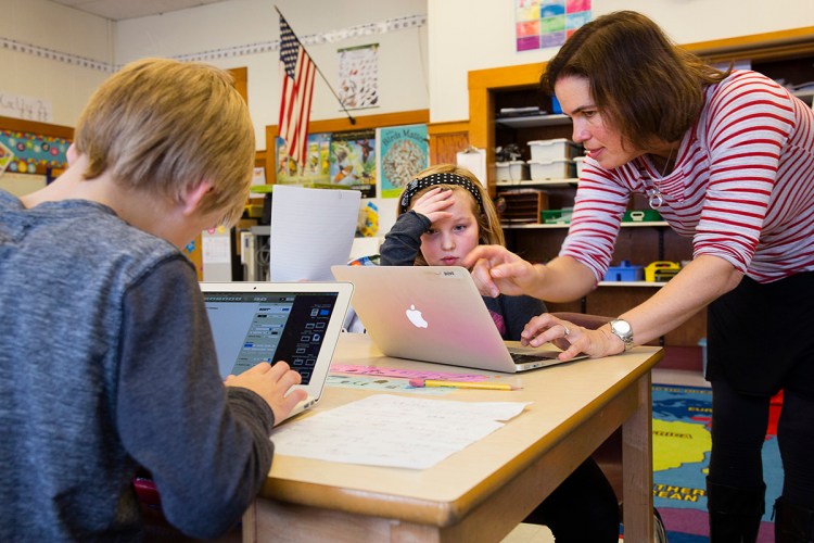 In this file photo from 2016, a Chebeague Island School third grader receives assistance from teacher Kristin Westra. Westra has been missing since Sunday night and a search is being conducted.