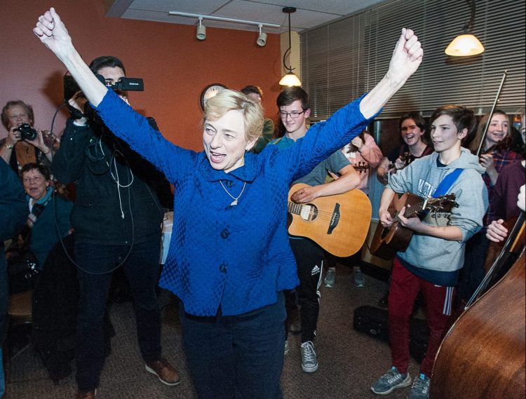 Janet Mills reacts as she enters The Homestead Kitchen, Bar & Bakery on Wednesday night in downtown Farmington, where dozens more people were waiting inside to welcome home the governor-elect.