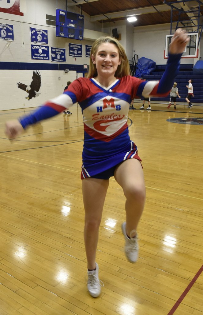 Messalonskee High School student Kaitlyn Berthiaume is the school's sole cheerleader. Berthiaume practices Thursday at the Oakland school gymnasium.