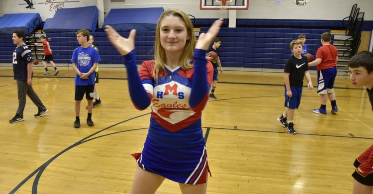 Messalonskee High School student Kaitlyn Berthiaume is the school's sole cheerleader. Berthiaume practices Thursday at the Oakland school gymnasium.