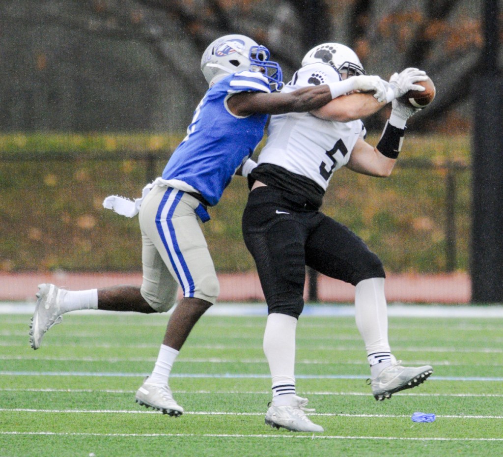 Colby's Asher Inman, left, tackles Bowdoin's Andrew Tichy as he makes a catch Saturday in Waterville.