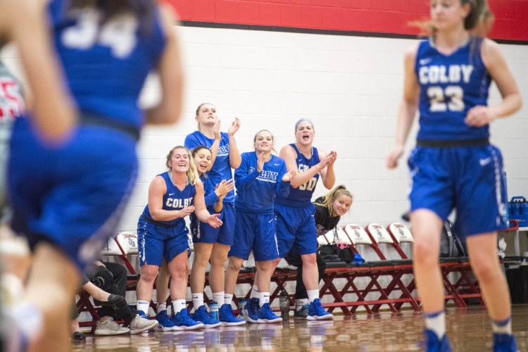 Staff photo by Michael G. Seamans 
 The Colby College bench celebrates a three-pointer against Thomas College in the first period at Thomas College in Waterville on Tuesday.