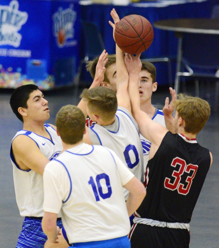 The Messalonskee boys basketball team battles Hall-Dale for a rebound during a Capital City Tip-Off game Friday at the Augusta Civic Center.