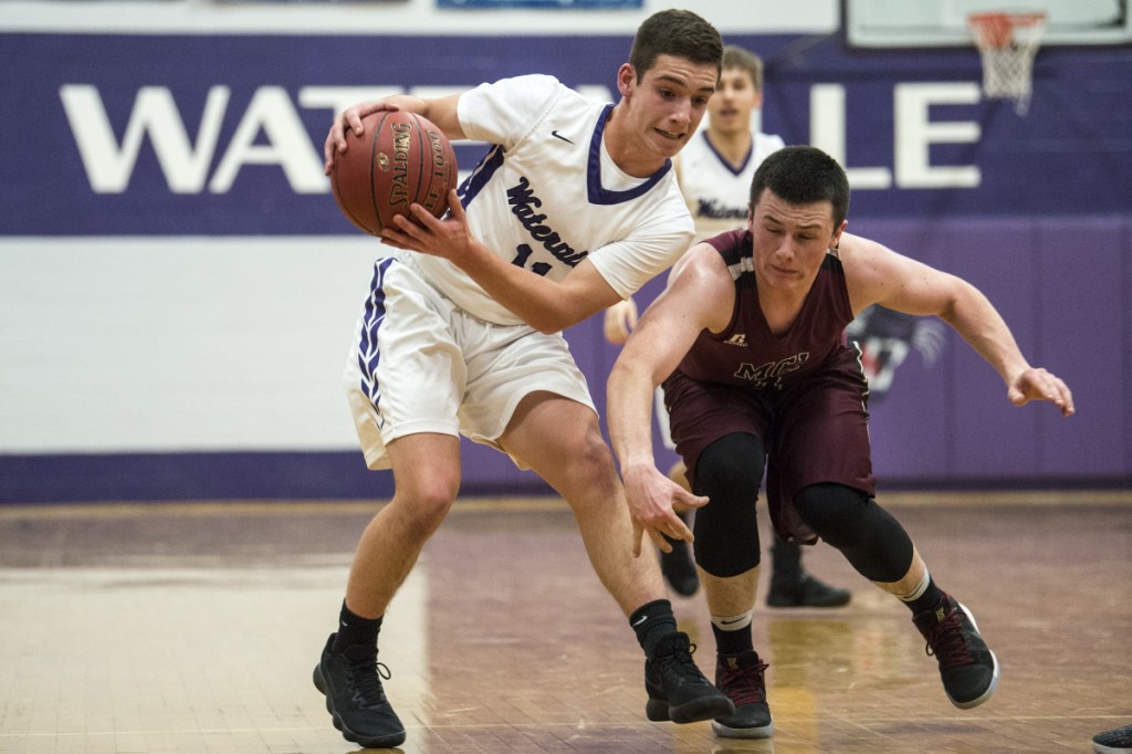 Preventative measure: Waterville's Ben Danner, left, grabs the ball as Maine Central Institute defender Owen Williams closes in during a game last season in Waterville.