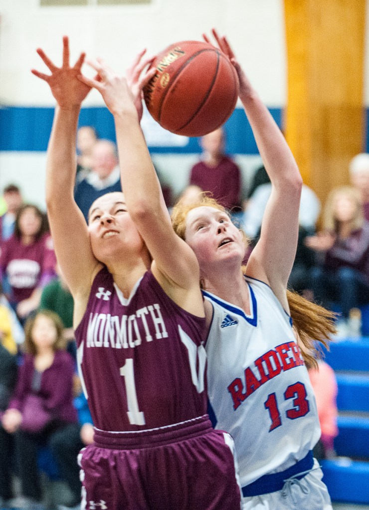 Oak Hill's Desirae Dumais wrestles a rebound from Monmouth's Abby Flanagan and turned and scored during the first half of Saturday's girls basketball game between Oak Hill and Monmouth in Wales.