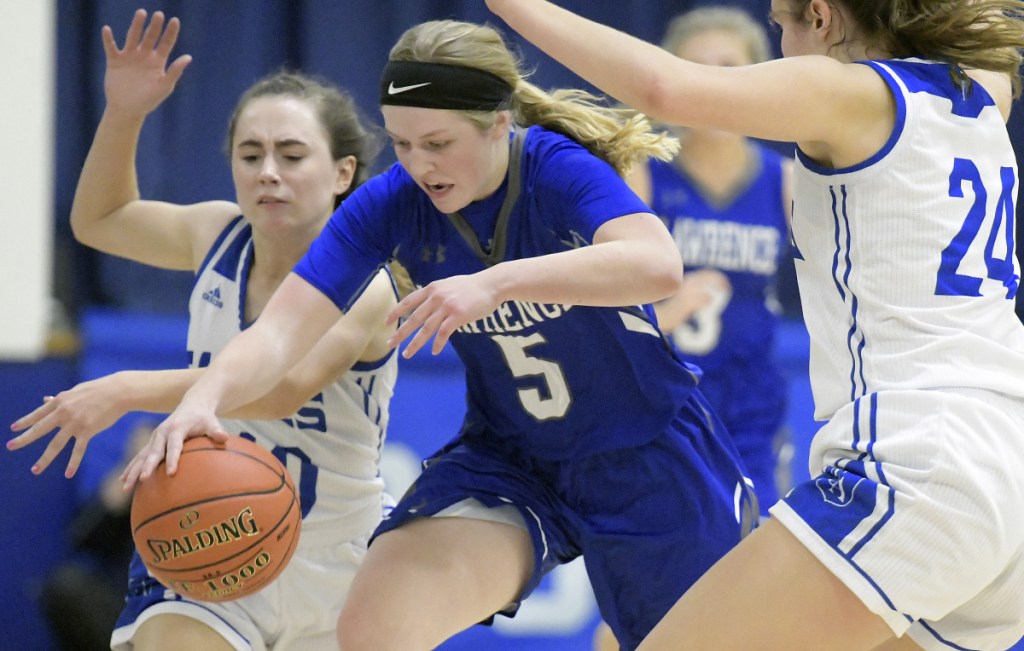 Erskine's Jordan Linscott, left, and Alyssa Savage try to trap Lawrence's Brooklyn Lambert during a Kennebec Valley Athletic Conference game Friday in South China.