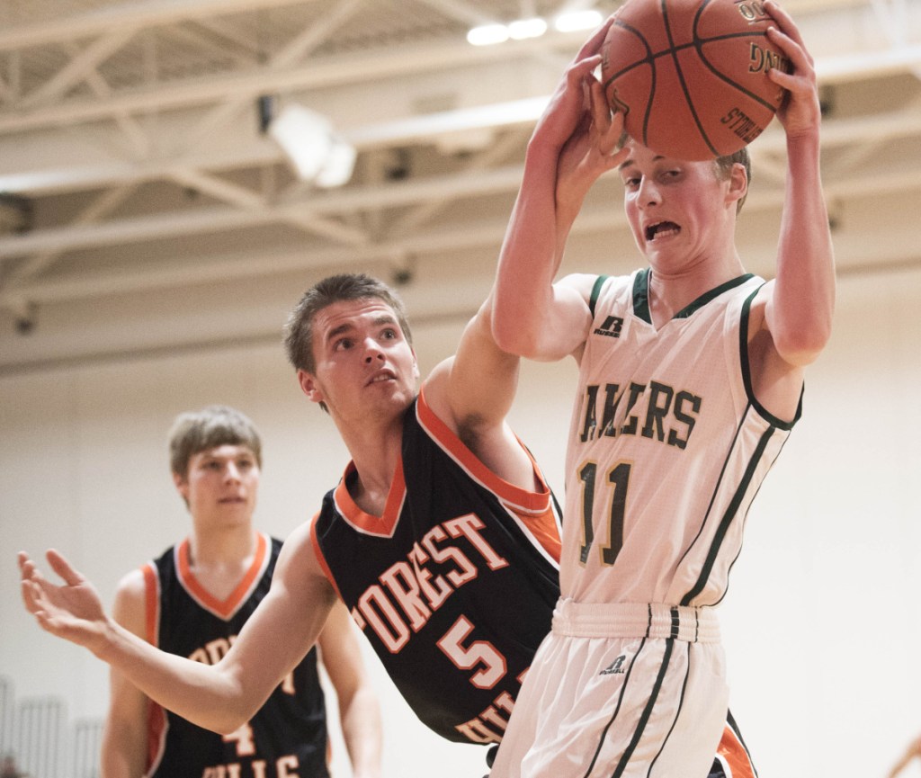 Rangeley's Nolan Boone (11) battles for the rebound with Forest Hills' Brandon Gilboe (5) on Saturday at Cony High School in Augusta.