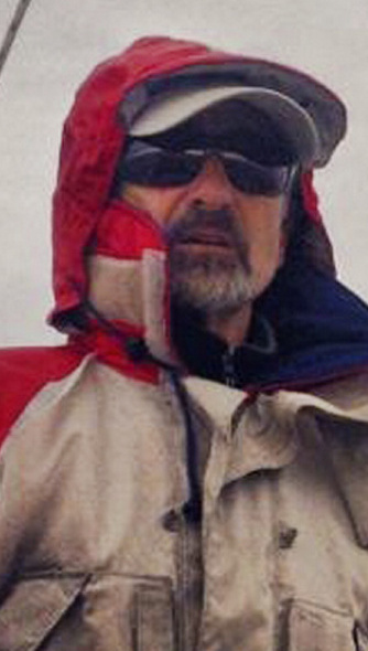 Capt. Rick Smith at the helm of his sailboat, Cimarron, in 2015.