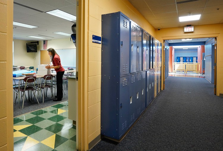 Science teacher Laurel Herendeen puts down a box while setting up her classroom at Scarborough Middle School in August. The school has received a $2,000 grant to support science, technology, engineering and math programs.