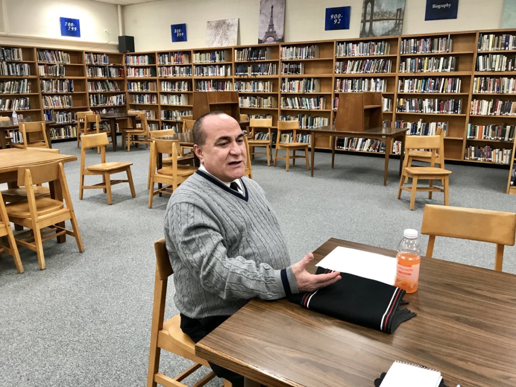 Residents of School Administrative District 49 towns listen to Superintendent Reza Namin speaking about his plans for administrative restructuring during a meeting Friday evening at Lawrence High School in Fairfield.