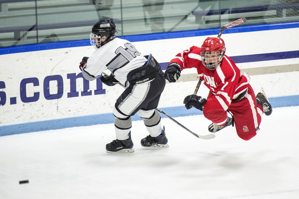 Cony's Elijah Bezanson, right, trips over Kennebec's John Evans on Wednesday at Colby College in Waterville.