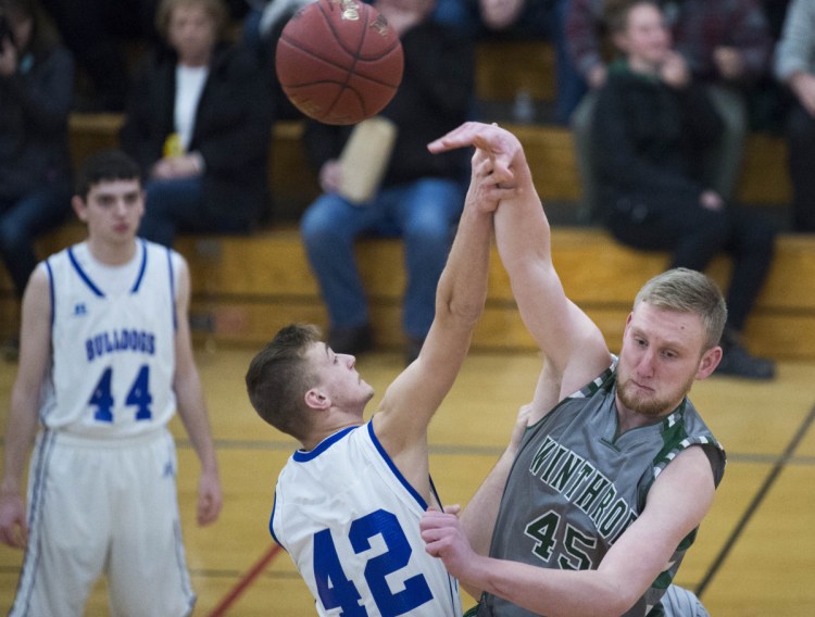 Winthrop's Cam Wood (45) wins the tip against Madison's Thomas Dean (42) to begin the game Thursday in Madison.