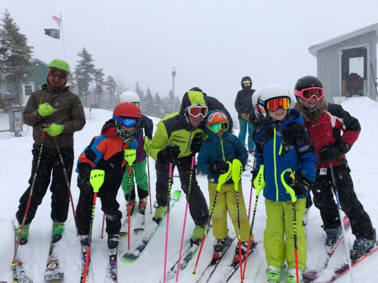 Extreme skier Glen Plake and his wife, Kimberly, pose with children at Black Mountain of Maine in Rumford on Jan. 19. 