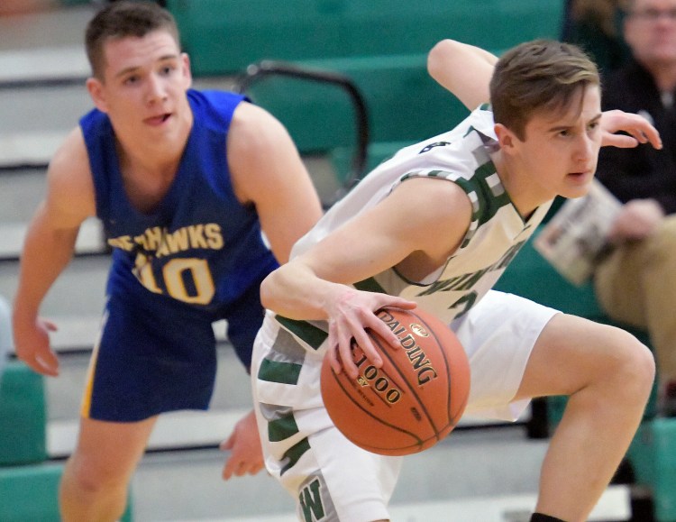 Winthrop's Cam Hachey dribbles past Boothbay's Hunter Crocker during a Mountain Valley Conference game last season in Winthrop.