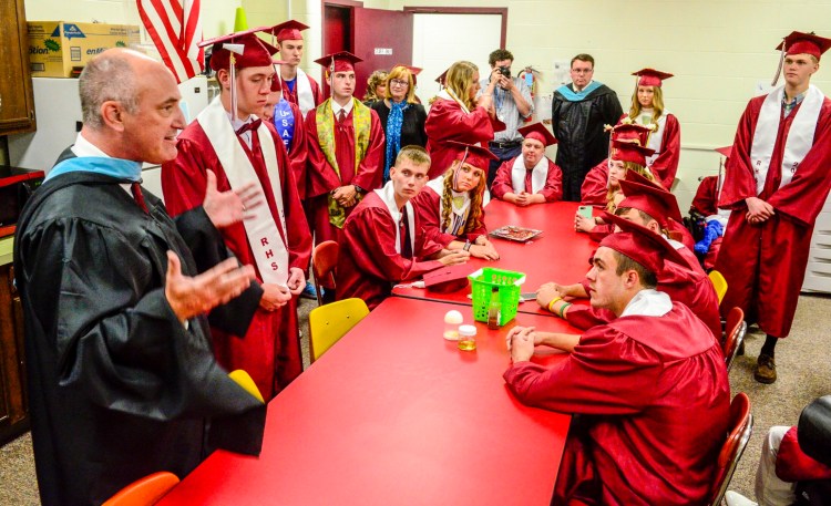 Regional School Unit 2 Superintendent William Zima, left, talks to students on June 9, 2018, before their graduation ceremony at Richmond High School.