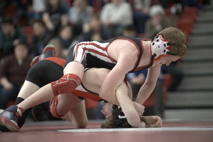 Camden Hills' Eric Andrews, top, tries to pin Cony's Noah Dumas during a 106-pound match at the Class A North championship Saturday at Camden Hills.