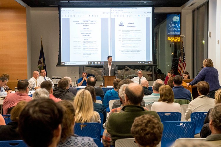 Mayor Nick Isgro opens the floor up for Community Notes as the Waterville City Council meets in its new home, The Chace Community Forum, in the new Colby dorm downtown on Oct. 2. Resident Julian Payne said he wants the venue for council meetings changed. Holding them in a Colby College-owned building represents a conflict of interest, Payne said, and it takes away second amendment rights to bear arms. 